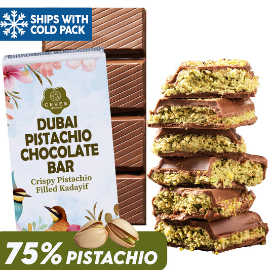The Viral Halloween Dubai Chocolate Bar by Ceres Gourmet (75% Pistachio, 7 oz) is shown with pieces of handcrafted chocolate revealing pistachio and kadayif filling. The packaging highlights premium pistachio cream and includes a cold pack for shipping.