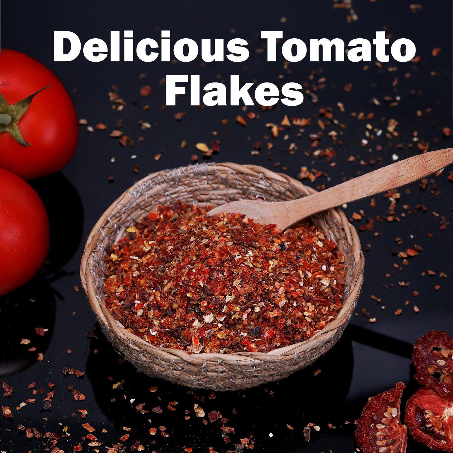 A woven bowl with Ceres Gourmet Dried Tomato Powder – 5.3 oz, 100% Pure, and a wooden spoon, surrounded by whole and sliced tomatoes on a black surface. Text above reads: Delicious Tomato Flakes. Perfect for sauces, soups, paste & more.