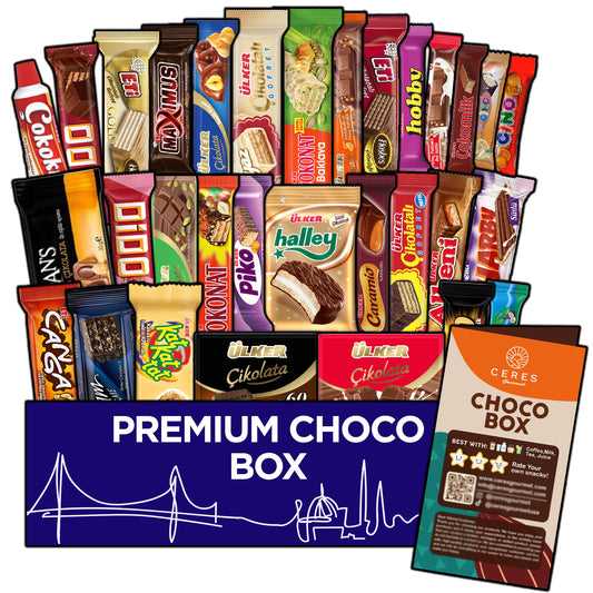 An array of vibrant international chocolate treats is displayed above a blue box labeled “International Chocolate Variety Box 31 Pieces 🍫” from Ceres Gourmet, with a Ceres Gourmet product information card nearby.