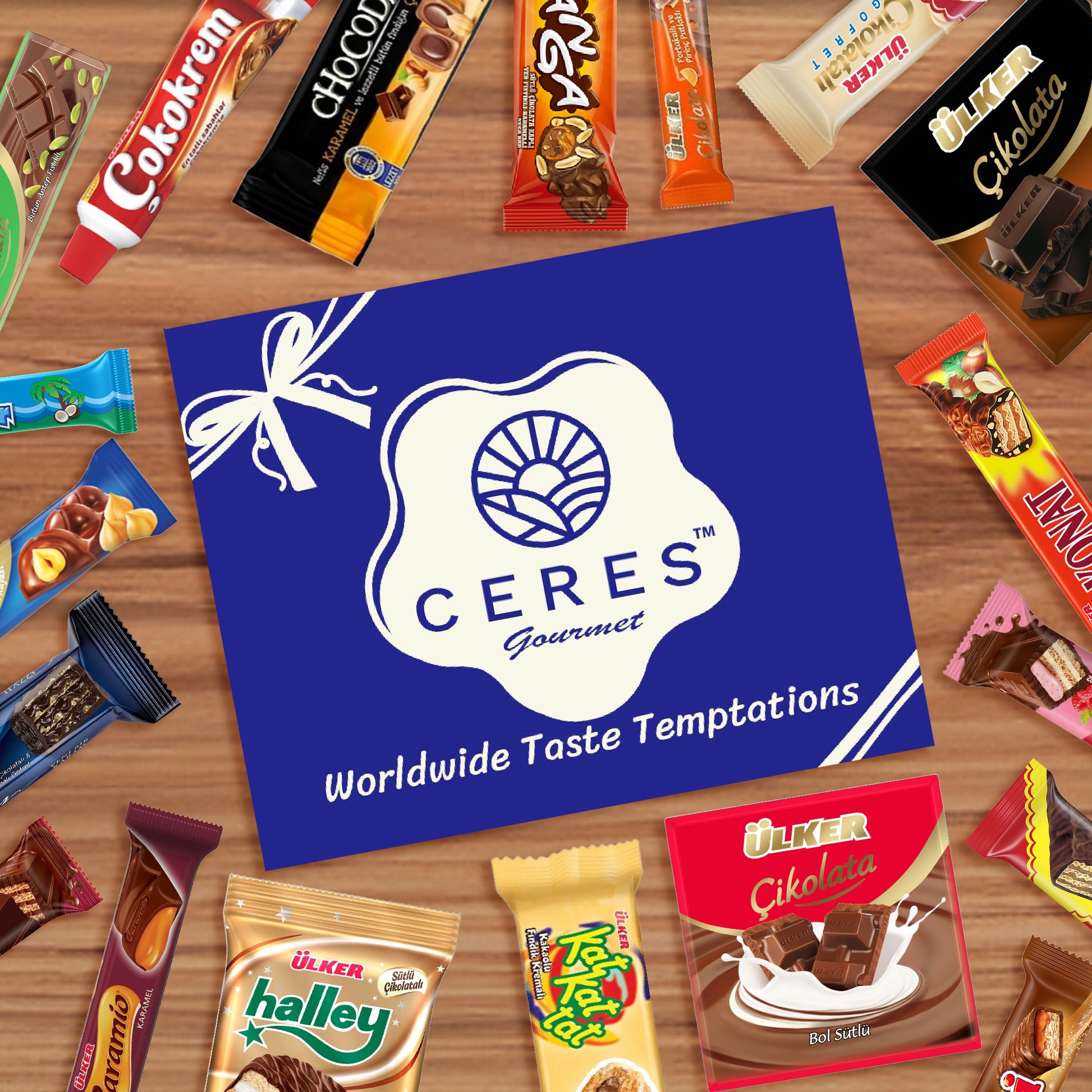A blue Ceres Gourmet card with a white logo and the slogan Worldwide Taste Temptations is surrounded by 31 pieces of exotic chocolate and colorful Turkish candy snacks from the International Chocolate Variety Box on a wooden surface.