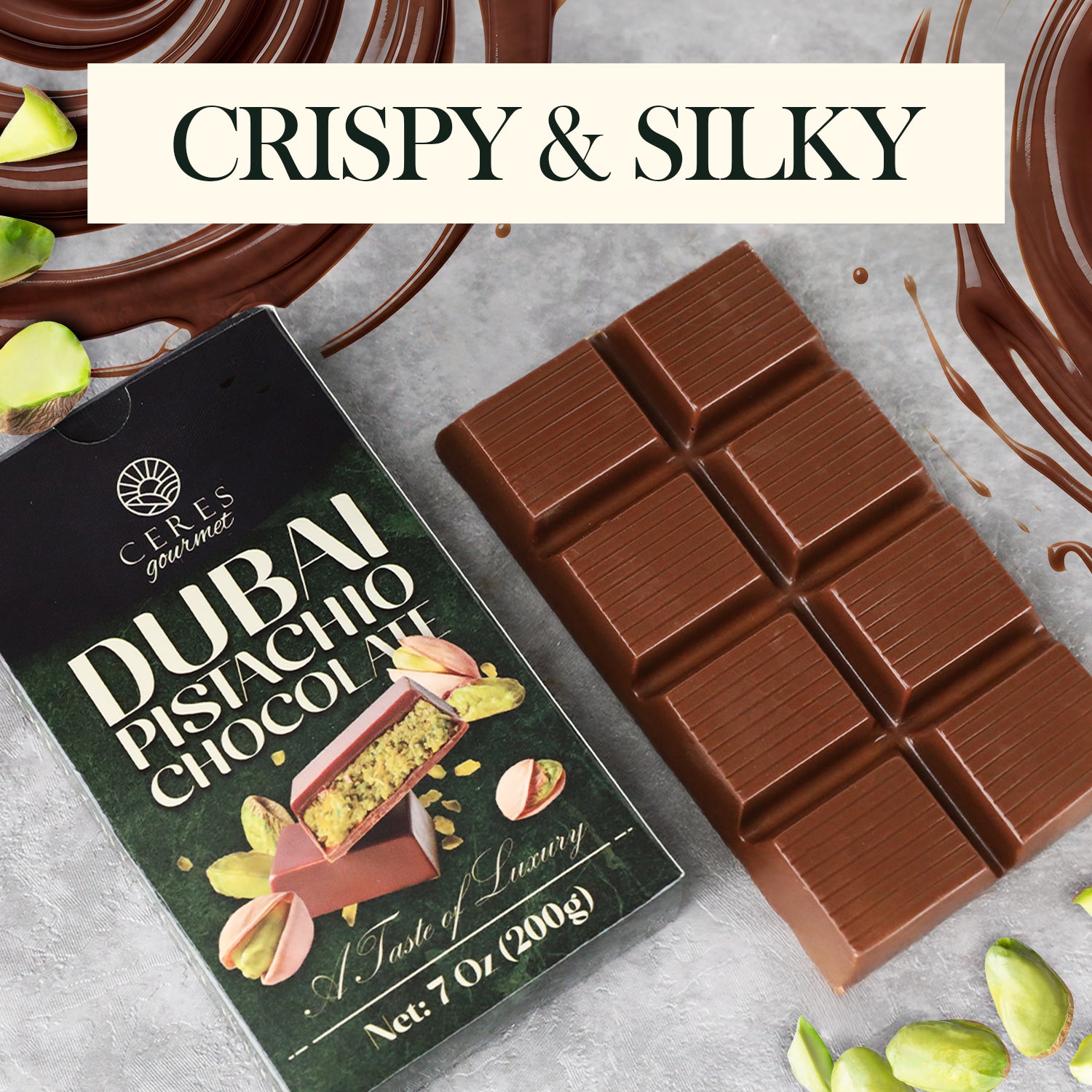 The Ceres Gourmet Dubai Chocolate Pistachio Bar – 7oz (200g) rests next to its “Dubai Pistachio Chocolate” box, surrounded by melted chocolate and pistachios, with “CRISPY & SILKY” at the top—ideal for gourmet chocolate enthusiasts.