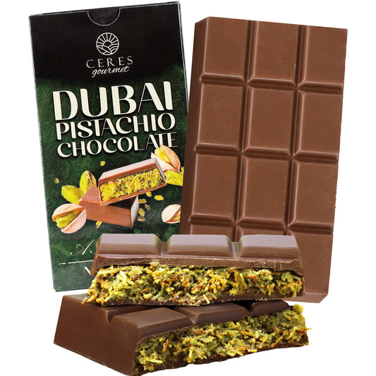 The Ceres Gourmet Dubai Chocolate Pistachio Bar (2.3oz/65g) is shown before its packaging, which highlights pistachios and chocolate pieces—a truly gourmet treat for chocolate lovers.