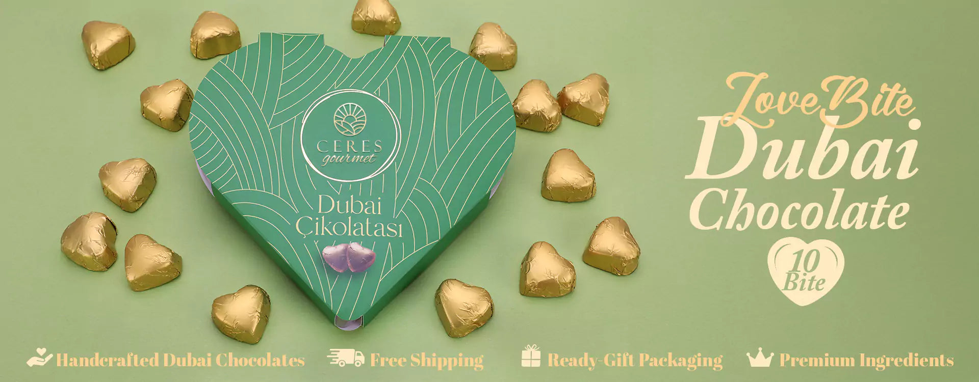 A green, heart-shaped box labeled Ceres Gourmet Dubai Cikolatasi is surrounded by gold-wrapped heart-shaped chocolates. Text on the right reads Love Bite Dubai Chocolate, 10 Bite with icons for free shipping and premium ingredients.
