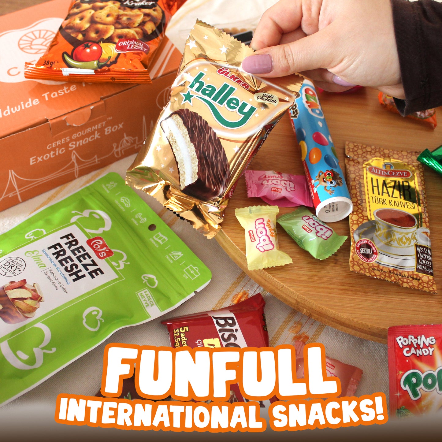 A hand picks up a treat from the Ceres Gourmet International Snack Box, featuring 12 unique snacks and over 15 pieces in a colorful display. The text FUNFULL INTERNATIONAL SNACKS! appears at the bottom.