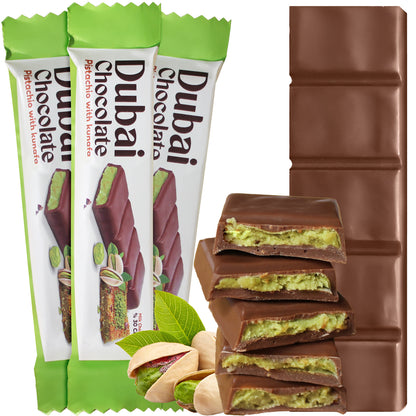 Three Ceres Gourmet Dubai Chocolate Pistachio Kunafa Bars, each 1 oz and wrapped in green and white, display their square segments and pistachio filling, evoking a rich Middle Eastern dessert alongside pistachios and green leaves.