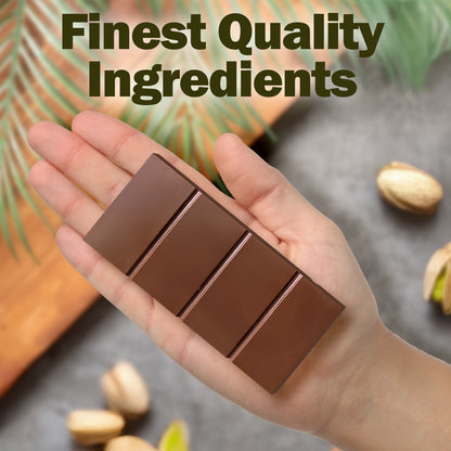 A hand holds a Ceres Gourmet Dubai Chocolate Bar Pistachio with Milky Chocolate and Knafeh (3.5 oz), divided into four sections. Pistachios, green leaves, and Finest Quality Ingredients highlight this premium treat in the background.