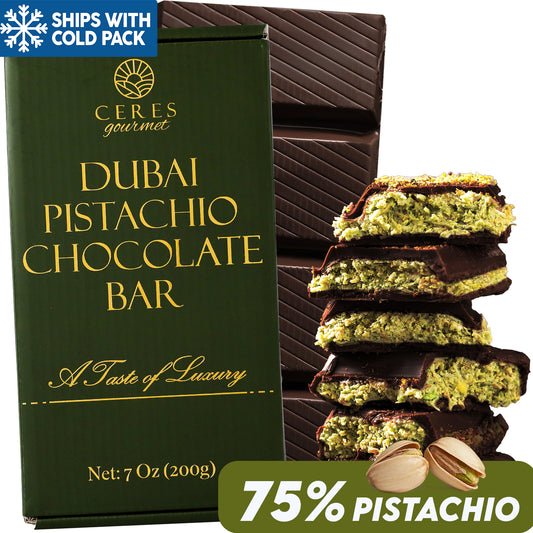 A green Ceres Gourmet Viral Dubai Chocolate Bar Dark 75% Pistachio 7 oz box stands beside stacked chocolate filled with pistachio cream. A 75% pistachio badge and nuts sit below, with Ships with cold pack text above.
