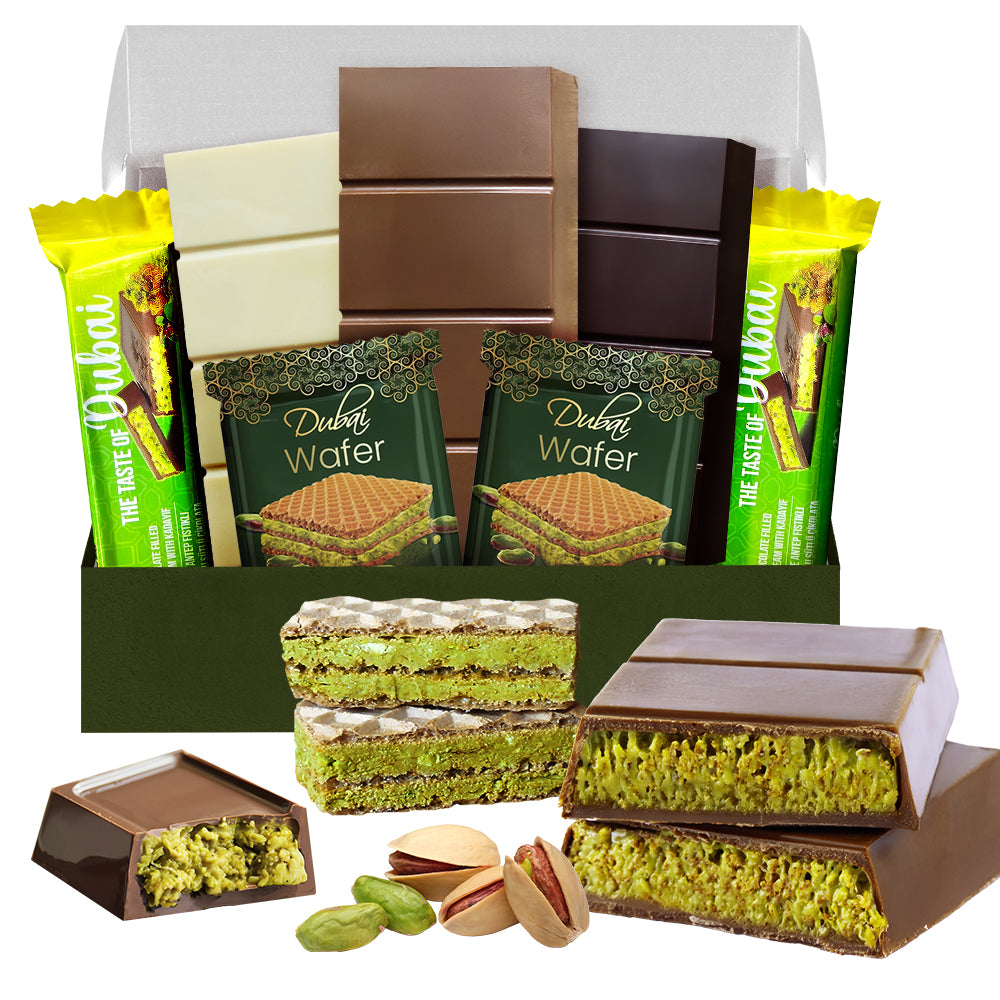 The Ceres Gourmet Dubai Chocolate Variety Pack – 7-Piece Gift Box includes white, milk, and dark chocolate pistachio bars, wafer bars, yellow-wrapped snacks, whole pistachios, and chocolate-covered wafers all displayed in front.