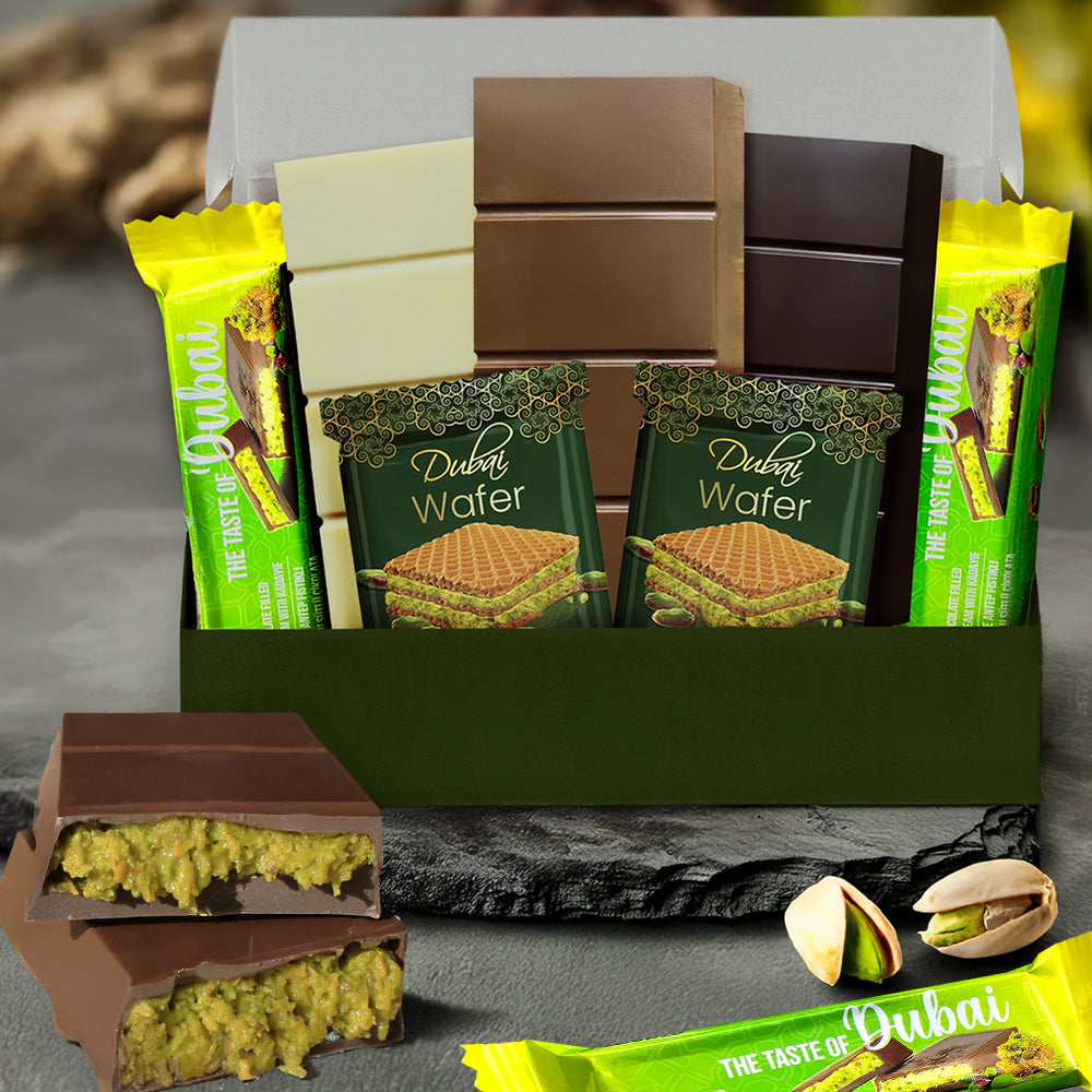 The Ceres Gourmet Dubai Chocolate Variety Pack – 7-Piece with Gift Box features assorted chocolate bars and Dubai Wafer snacks, beautifully arranged with pistachios. The green and yellow packaging is enhanced with decorative gold accents.