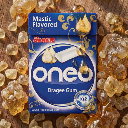 Ulker oneo mastic flavored dragee gum packaging on a wooden background with mastic pieces.