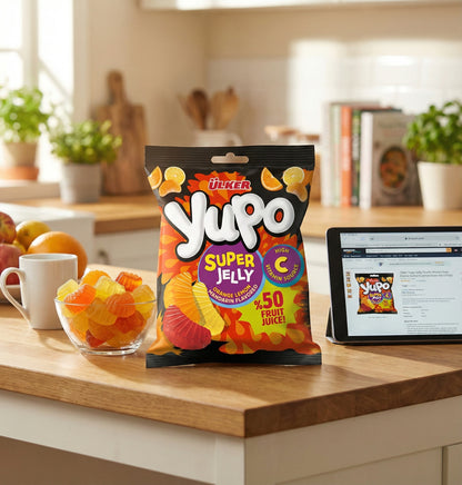 Yupo Super Jelly packet on a kitchen counter with a tablet displaying the product.