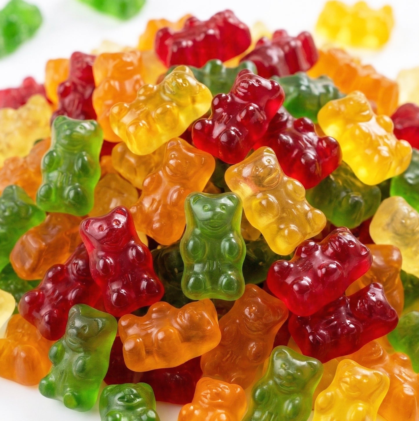 Assorted colorful gummy bears on a white background