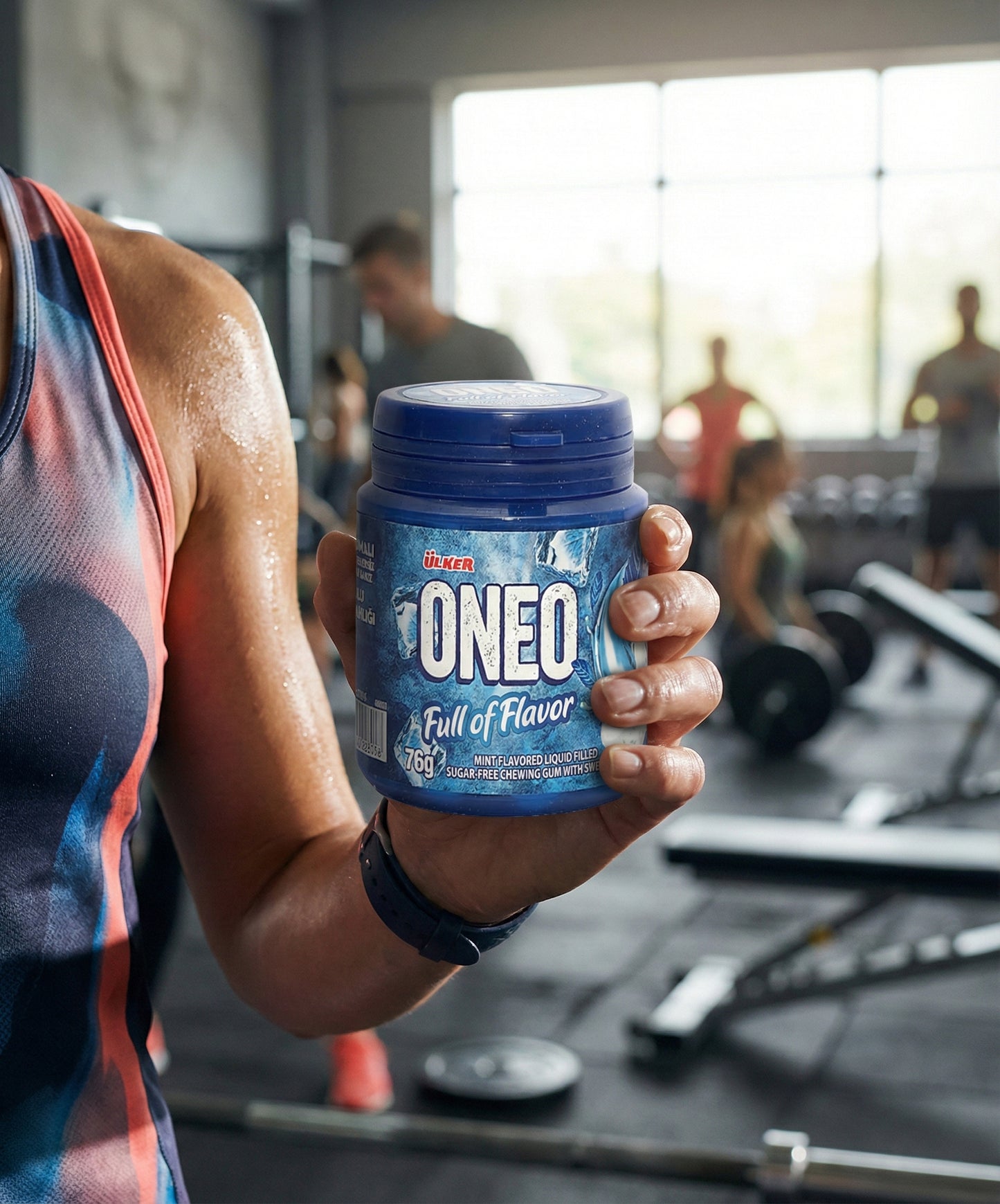 Person holding a container of ONEO supplement in a gym setting