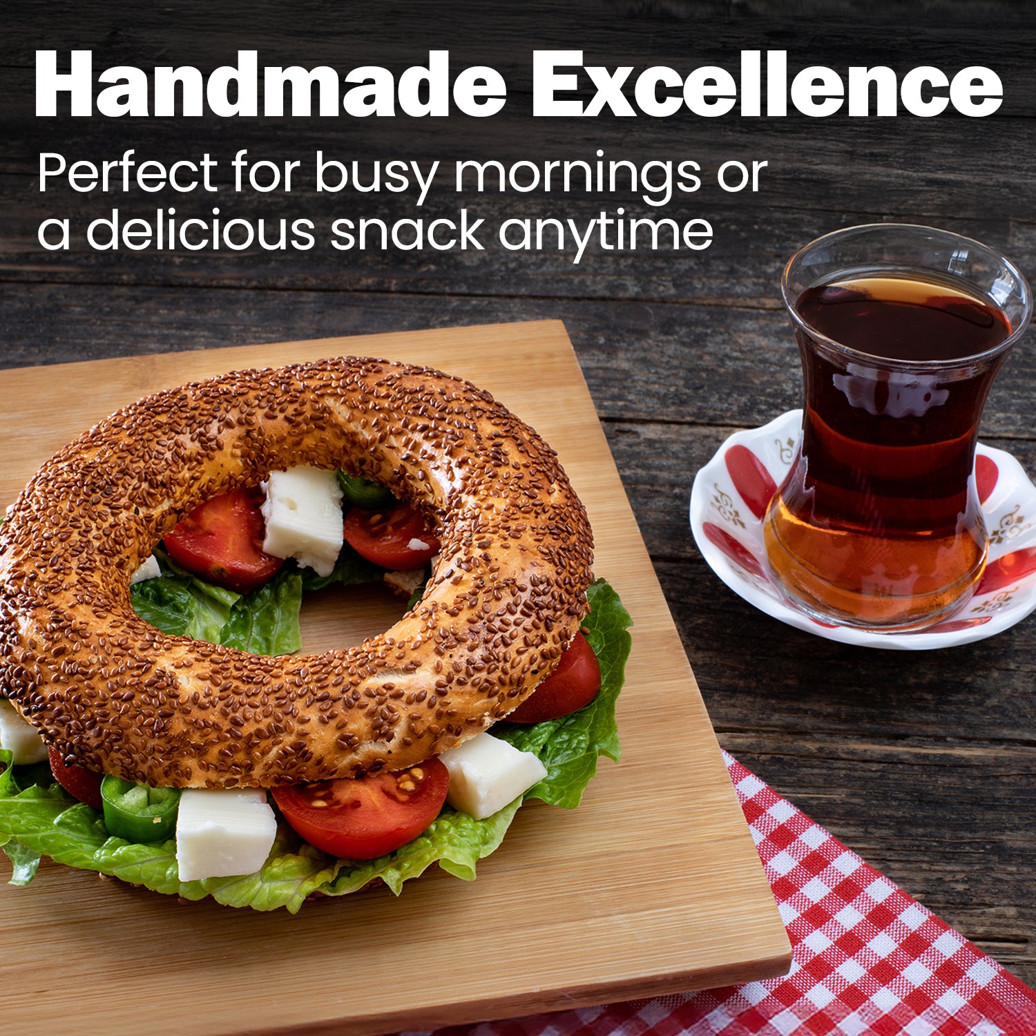 Handmade bagel sandwich with tea on a wooden board