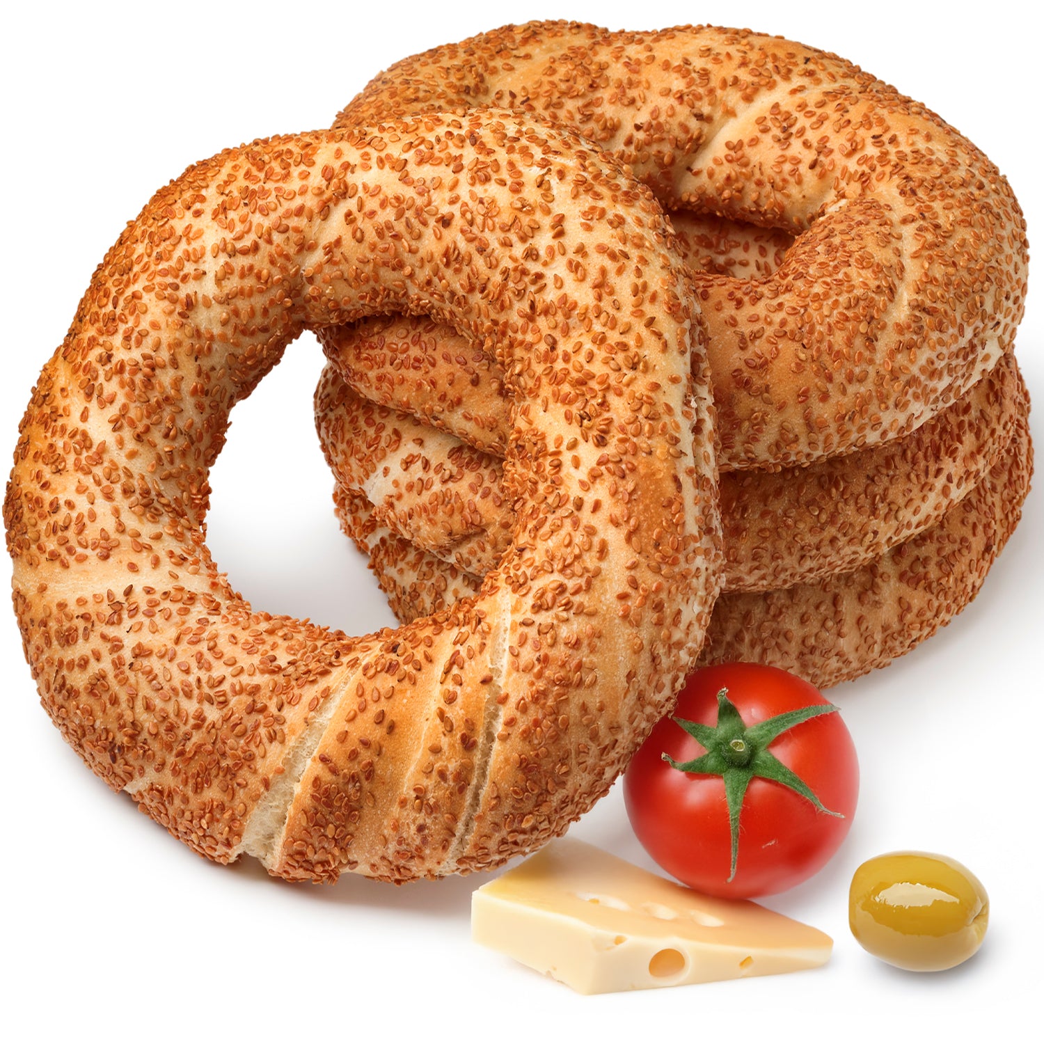 Stack of sesame seed bagels with a tomato, cheese, and olive on a white background