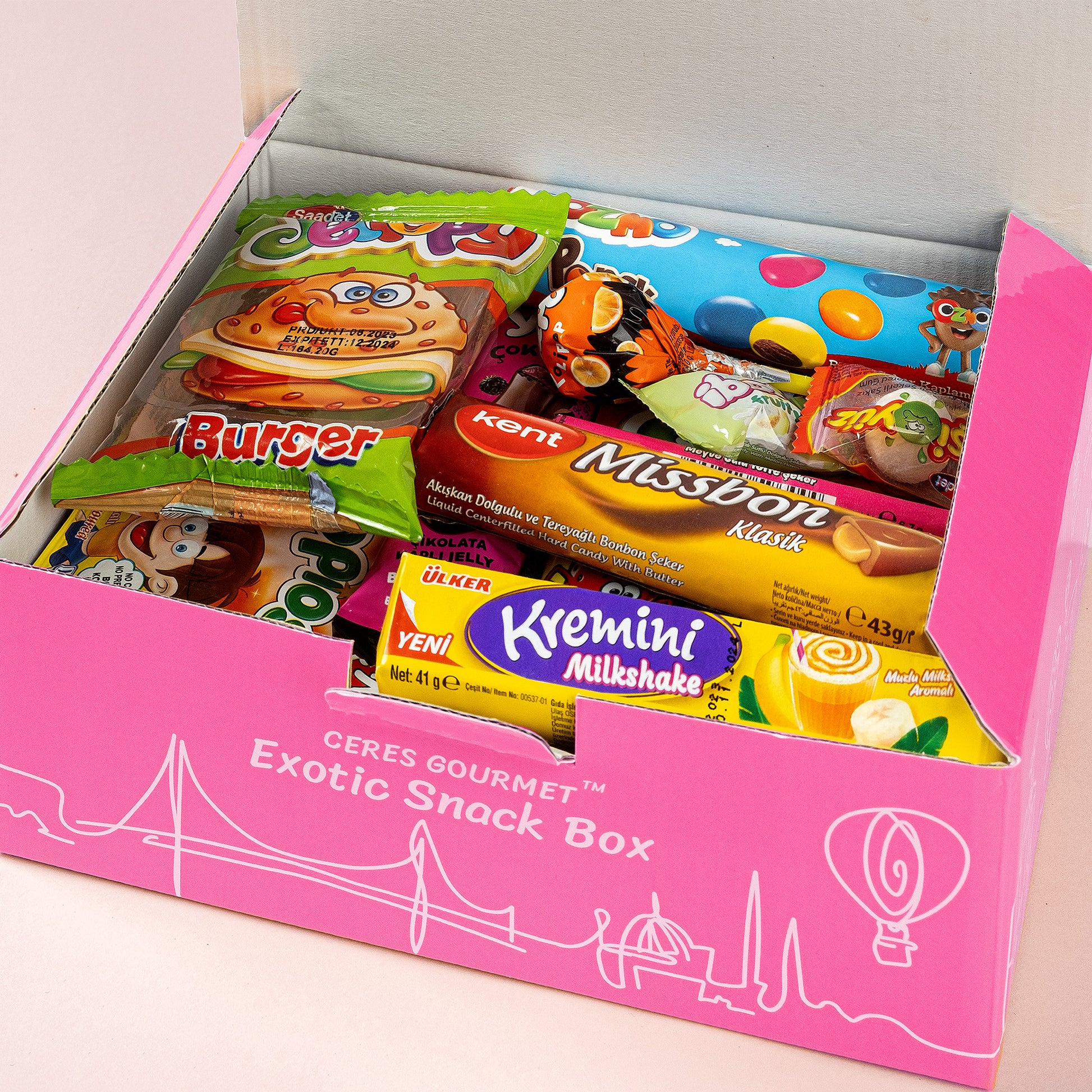 A Ceres Gourmet Candy Snacks Box Foreign Rare Unique 40 Mystery Candy 🍭 is open, showing a neat array of international wafers, cookies, candy bars, and a burger-shaped treat for a true exotic candy experience.