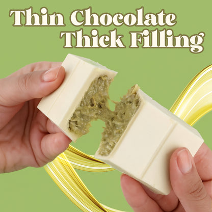 Hands holding a chocolate bar with a thick filling against a green background
