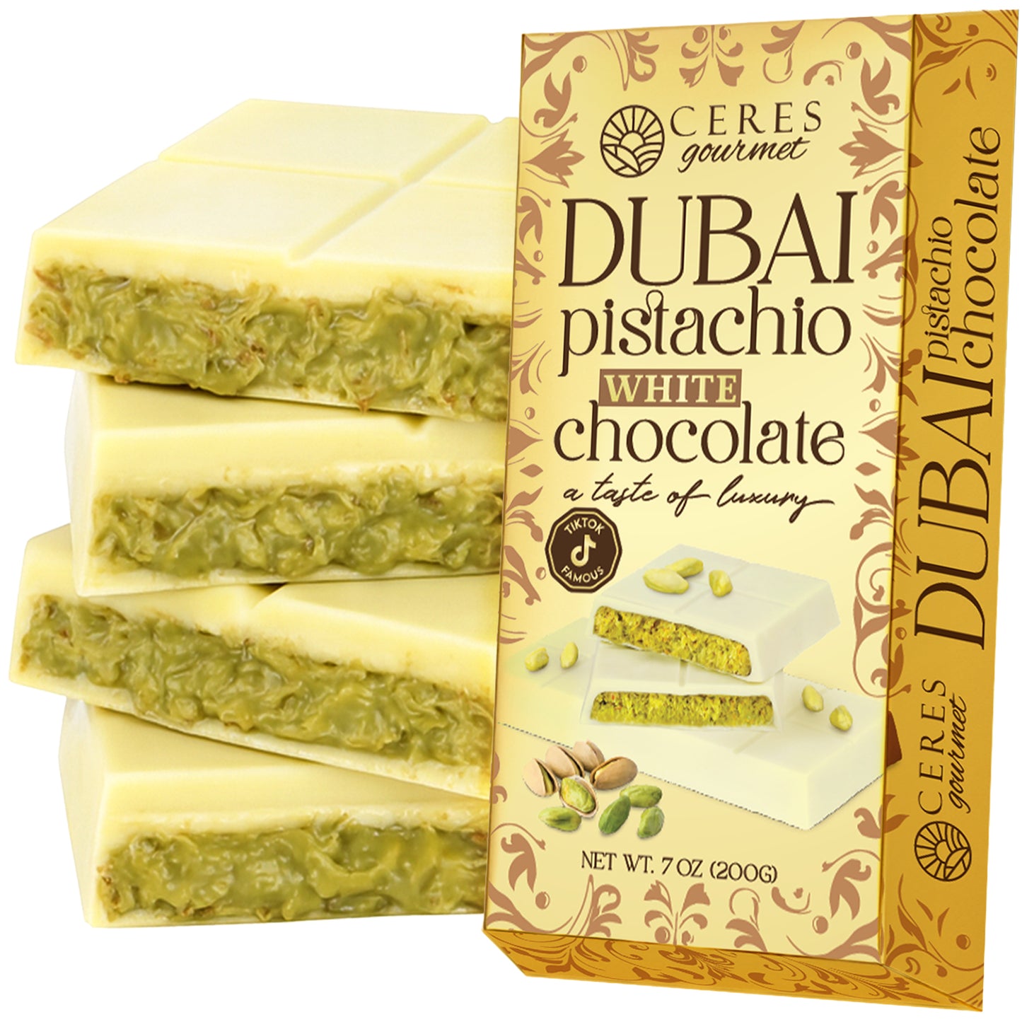 A box of Ceres Gourmet White Dubai Chocolate Crispy Knafeh Pistachio Bar 7oz is displayed next to bar pieces with a white chocolate coating and pistachio-filled center. The packaging shows enticing images of pistachios and chocolate.