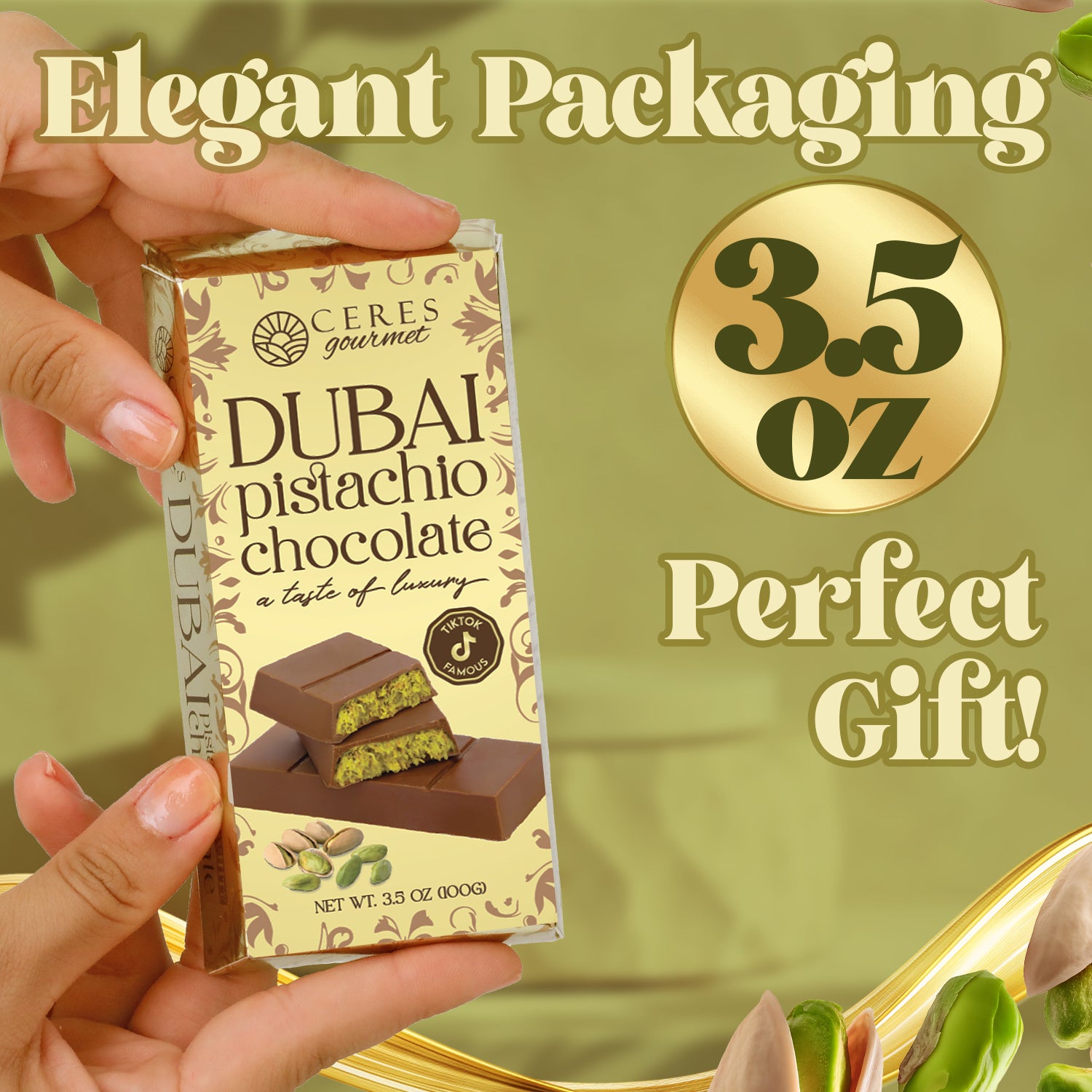A hand holds a box of Ceres Gourmet Dubai Chocolate Bar Pistachio with Milky Chocolate and Knafeh (3.5 Oz), featuring pistachios and chocolate pieces in elegant packaging—an ideal gift or luxurious treat.