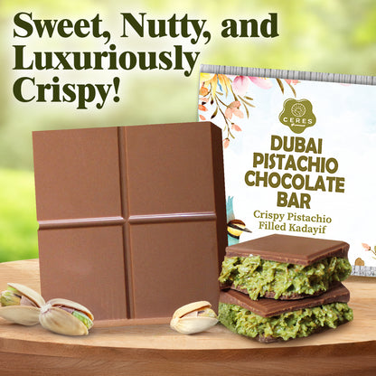 The Ceres Gourmet Dubai Chocolate Pistachio Bar 3.5 Oz Square, Luxury Halloween Chocolate, is shown with whole pistachios and its elegant box. Text: "Sweet, Nutty, Luxuriously Crispy!"—an indulgent Middle Eastern dessert gift on a green background.