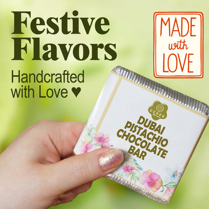 A hand holds a Ceres Gourmet Dubai Chocolate Pistachio Bar 3.5 Oz Square, Luxury Halloween Chocolate, in floral packaging. Text reads: Festive Flavors, Handcrafted with Love ♥, plus a red sign: Made with Love—a gourmet gift.