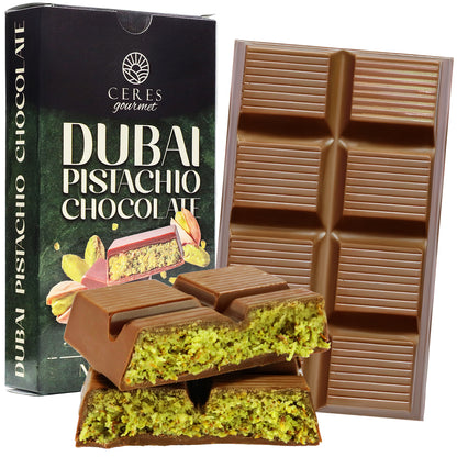 The Dubai Chocolate Pistachio Bar – 7oz (200g) by Ceres Gourmet is shown with its packaging, revealing pieces cut open to display the rich green pistachio filling inside this luxurious chocolate treat.