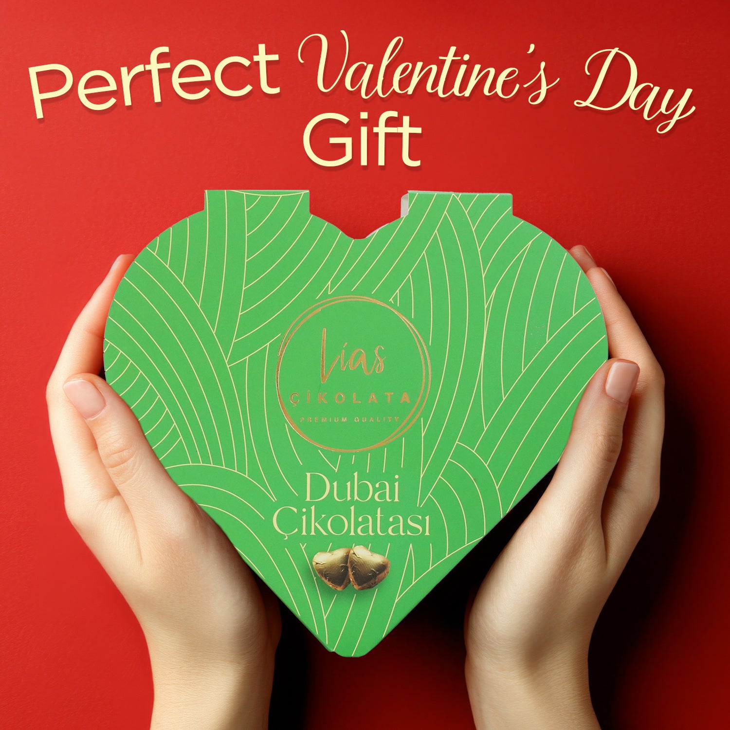 Hands holding a green, heart-shaped box of “Love Bite Dubai Chocolate Pistachio, 10 Bite-Size Pieces” by Ceres Gourmet against a red background, with “Perfect Valentine’s Day Gift” at the top.