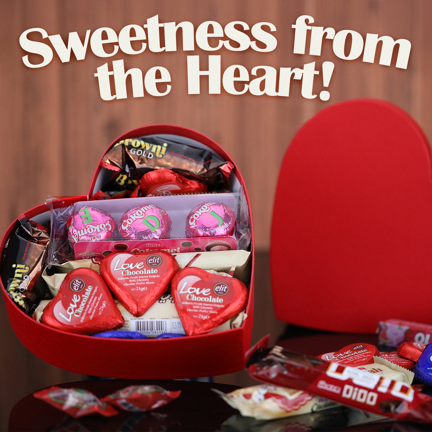 An open Love Box International Snacks for Your Special Someone 💖 by Ceres Gourmet overflows with global treats, surrounded by more snacks. Above, bold white text reads: Sweetness from the Heart!—the perfect Valentine’s Day gift.